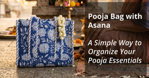 Blue floral printed Jaipur cotton pooja bag with asana, placed beside a diya and marigolds at a temple altar